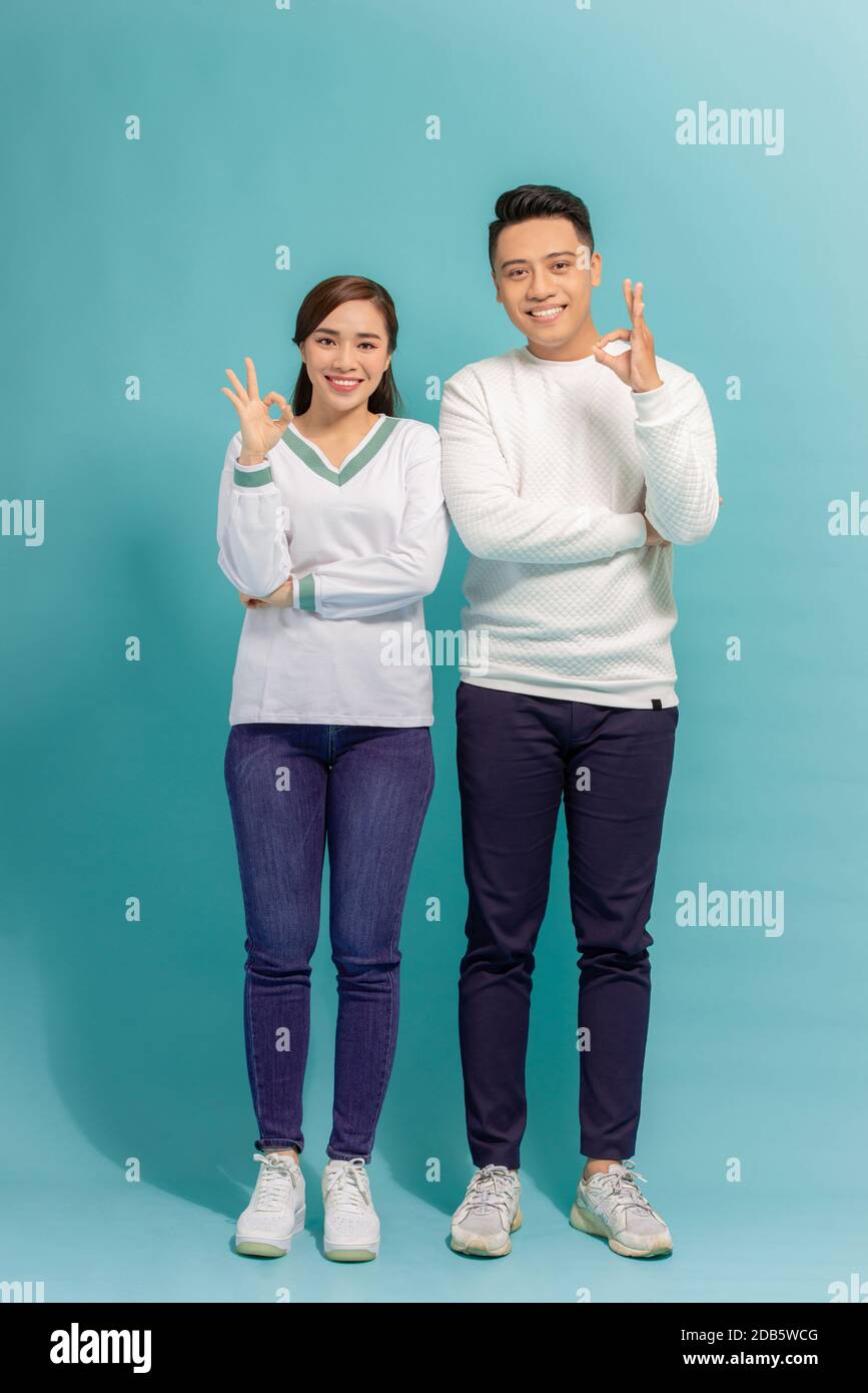 Happy Asian couple love excited smiling with ok hand gesture Stock Photo