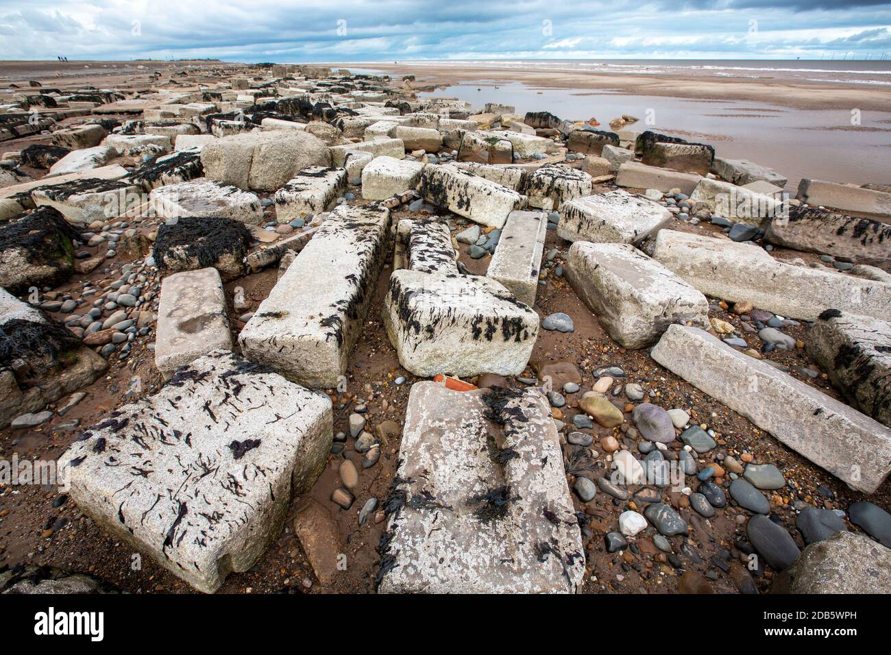 Coastal erosion breaking up old sea defences on Spurn point on Yorkshires East Coast, UK. This section of coastline is the fastest eroding coastline i Stock Photo