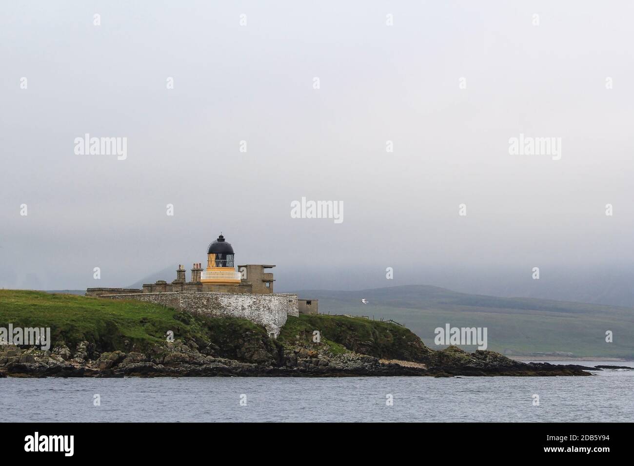 Graemsay Low lighthouse in the mist on orkney islands Stock Photo
