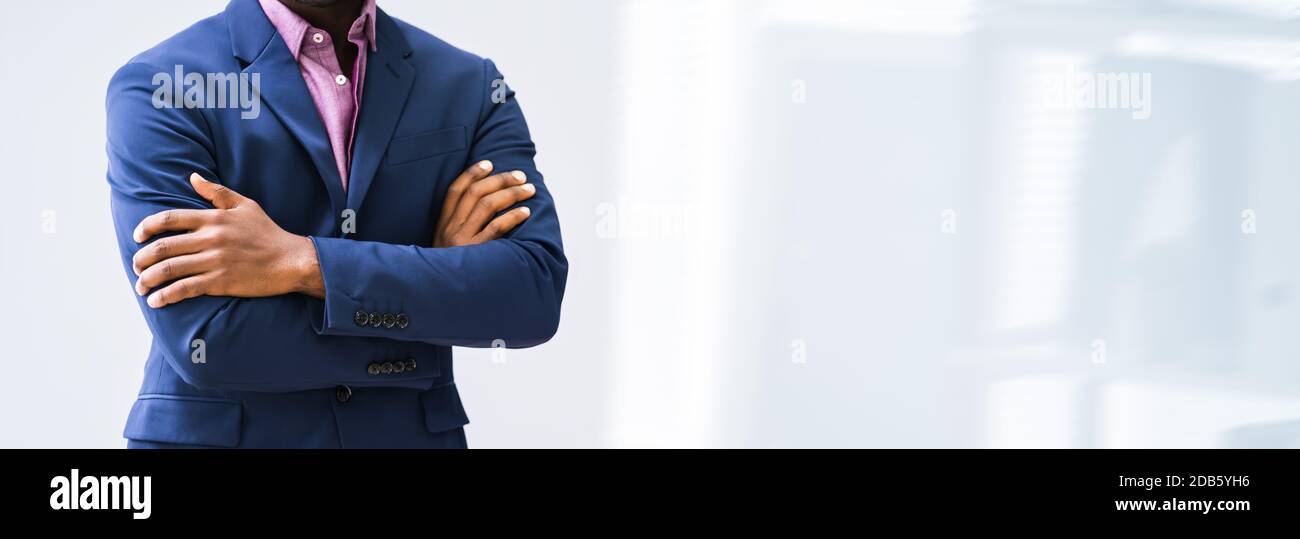 Portrait Of Confident Male Lawyer Standing Arms Crossed In Office Stock Photo