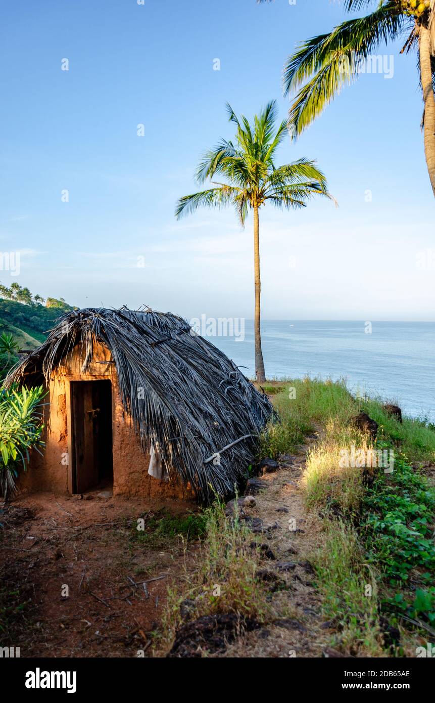 Small mud house with thatched roof inside Cabo de Rama Fort, Canacona, Goa, India Stock Photo