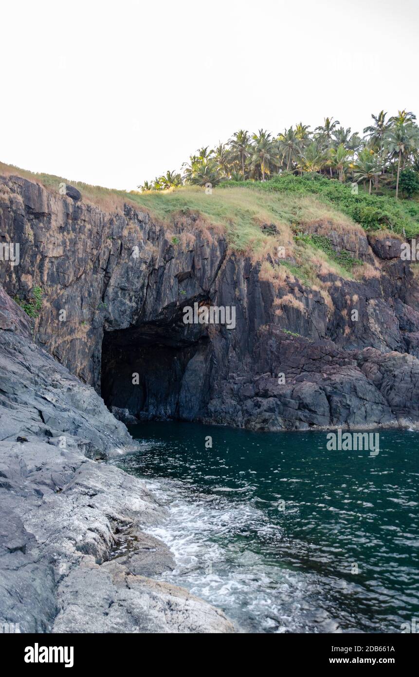 Sea cave in the rocky shoreline facing Arabian Sea inside Cabo de Rama Fort Complex, Canacona, Goa, India Stock Photo