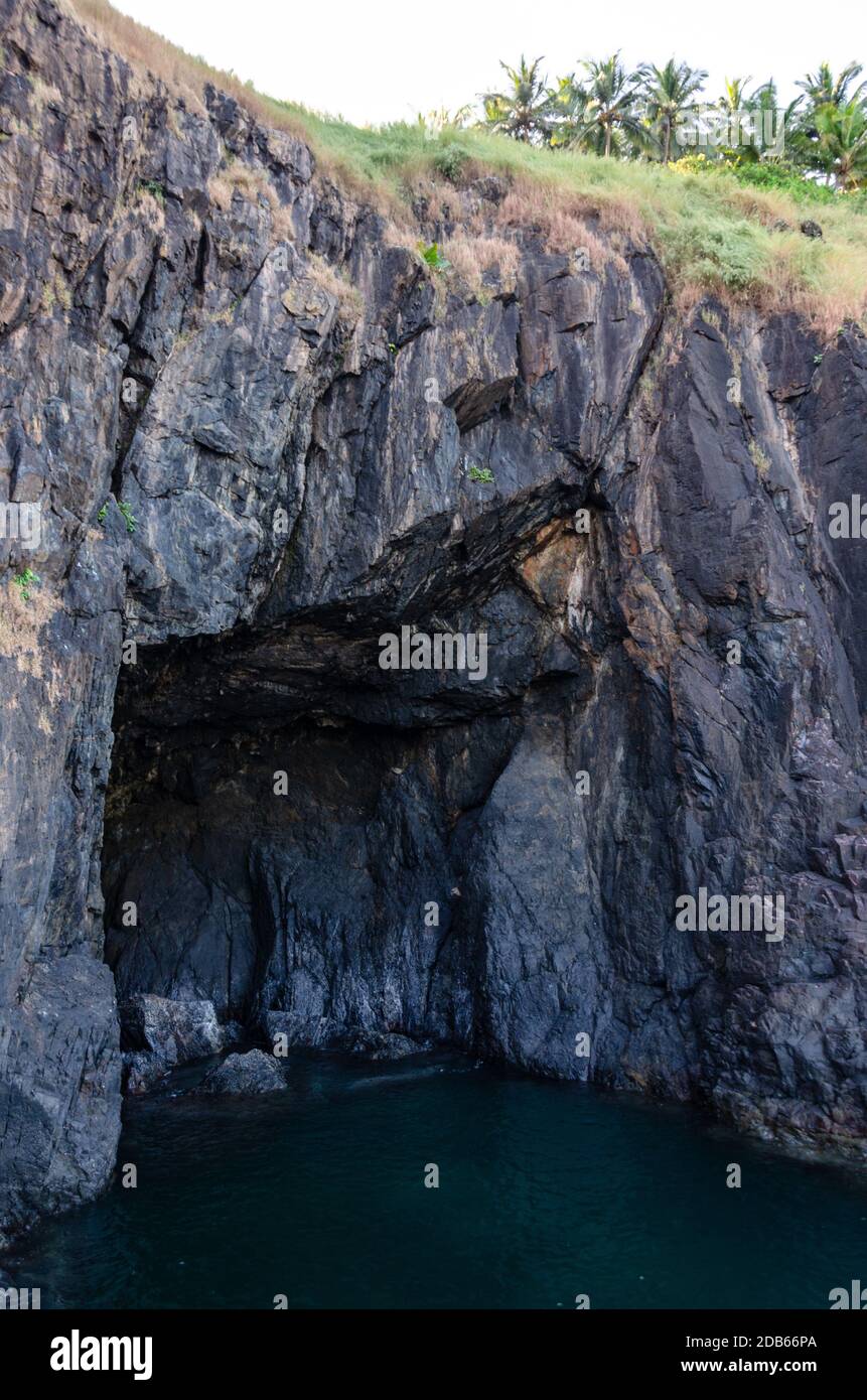 Sea cave in the rocky shoreline facing Arabian Sea inside Cabo de Rama Fort Complex, Canacona, Goa, India Stock Photo