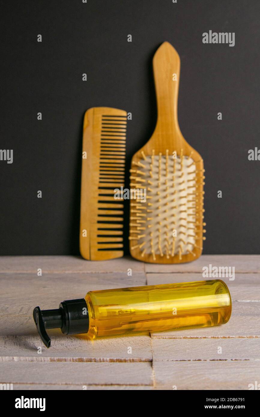 Hair gel and comb for haircut stand on a white table. Hairdressing