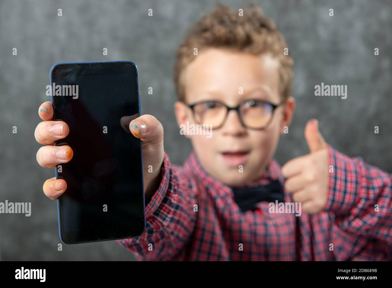 Little boy showing a smartphone black blank screen Stock Photo