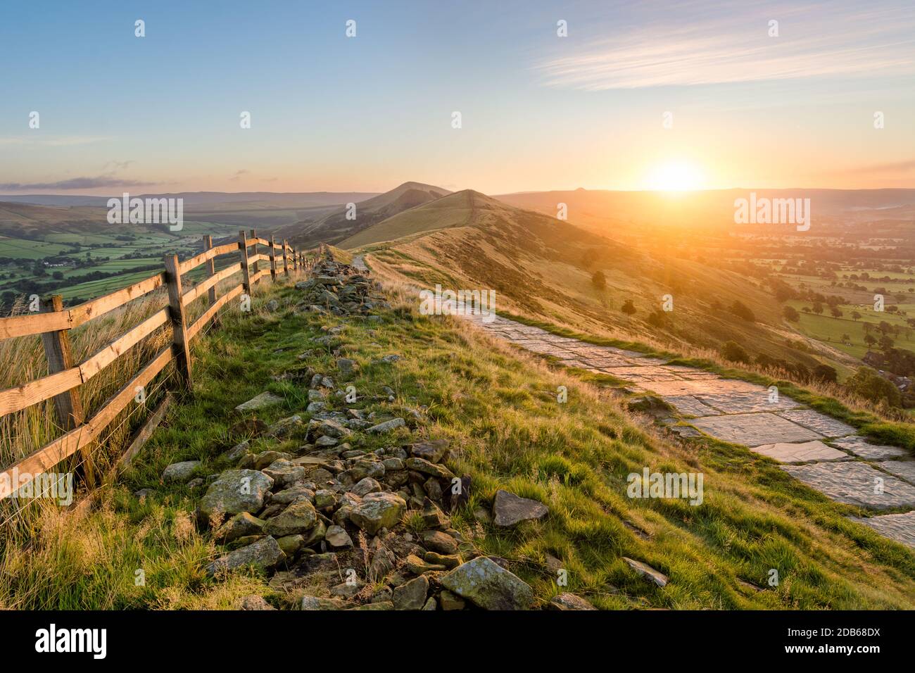 Stone footpath and wooden fence leading a long The Great Ridge in the English Peak District. Stock Photo