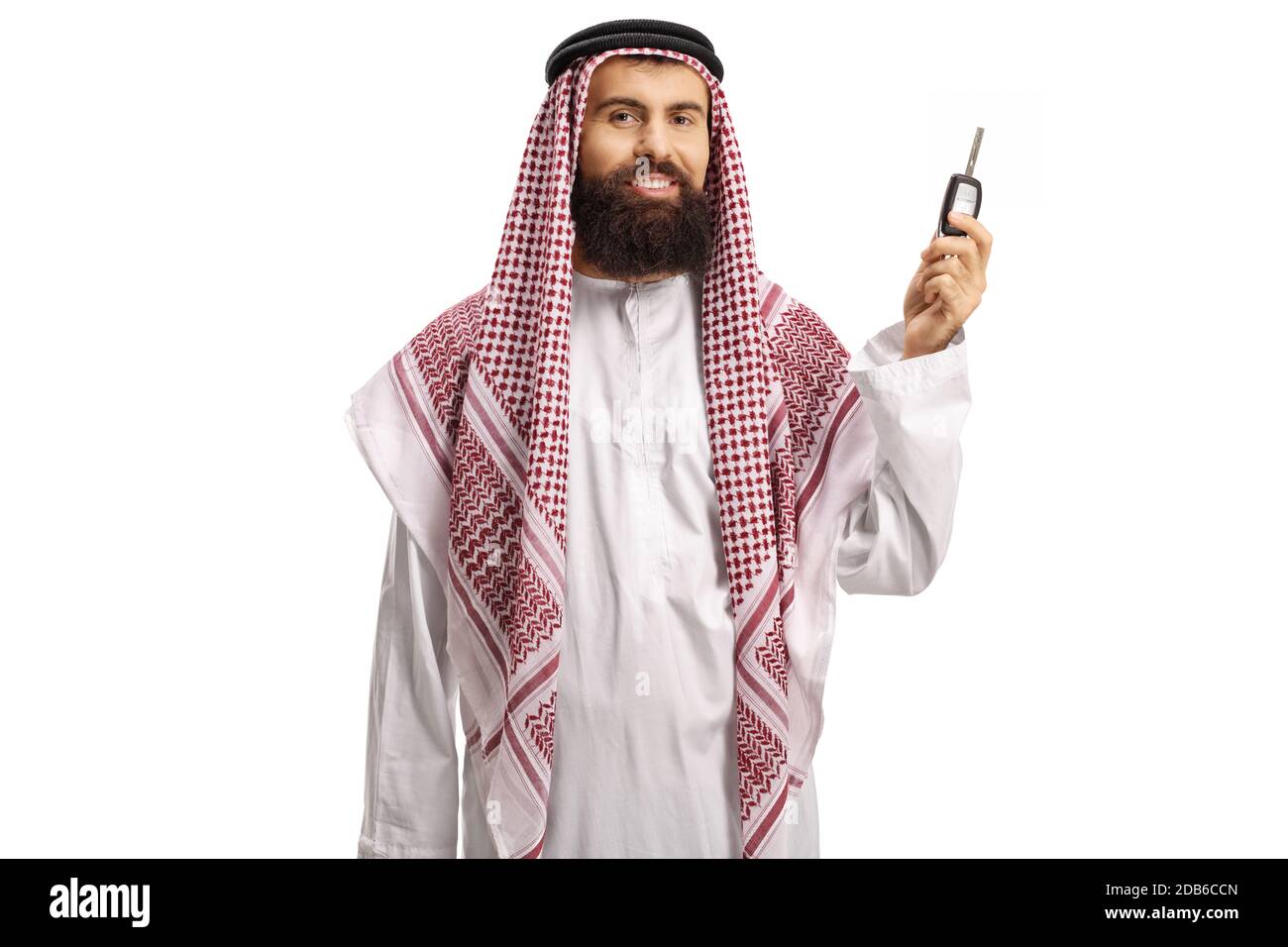 Saudi arab man holding car keys and smiling isolated on white background Stock Photo