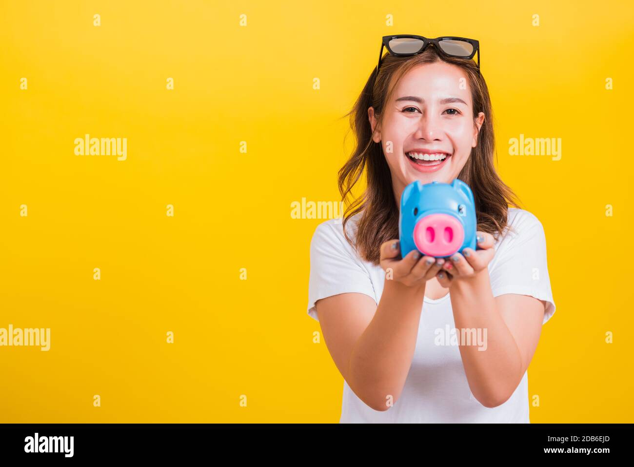 Portrait Asian Thai beautiful happy young woman smiling hold piggy bank ...
