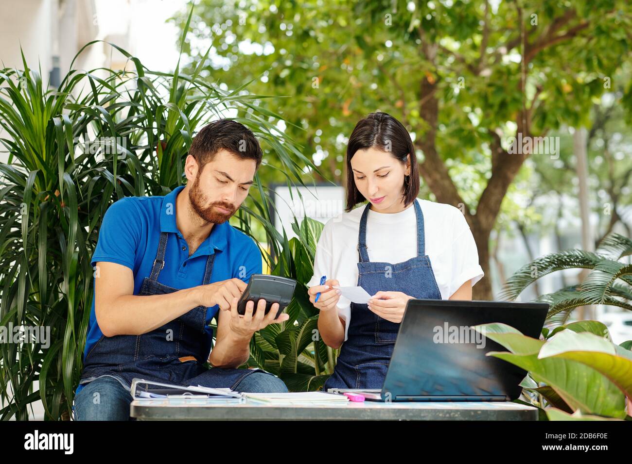 Cafe owners checking bills Stock Photo