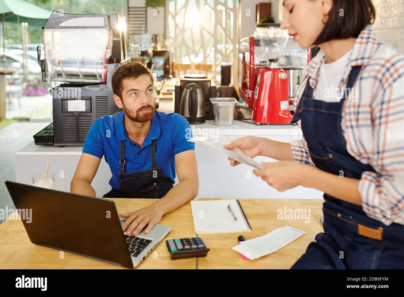Cafe owners checking bills Stock Photo