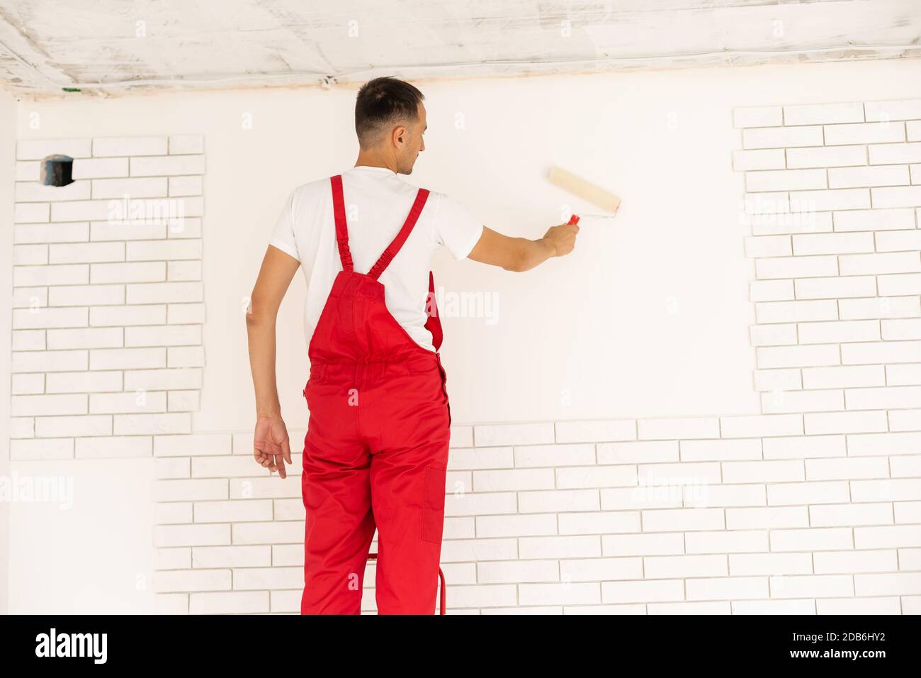 Man painting the wall, master wall painter Stock Photo Alamy