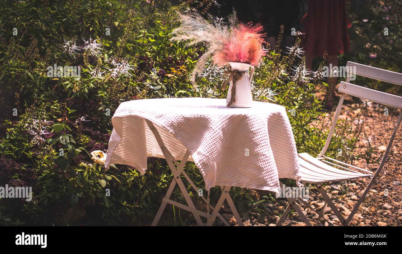 Table and Chair set decorate on A Garden for wedding Party or Celebration Outside. Stock Photo