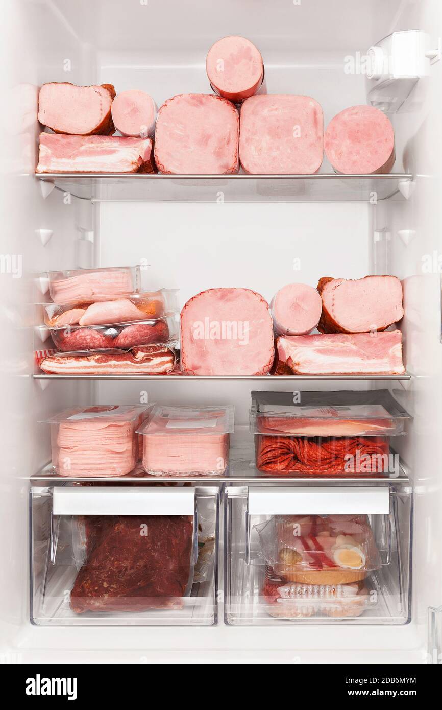 Carnivore diet. Full fridge of various meats. Beef, pork, backon, ham, sausauges. Stock Photo