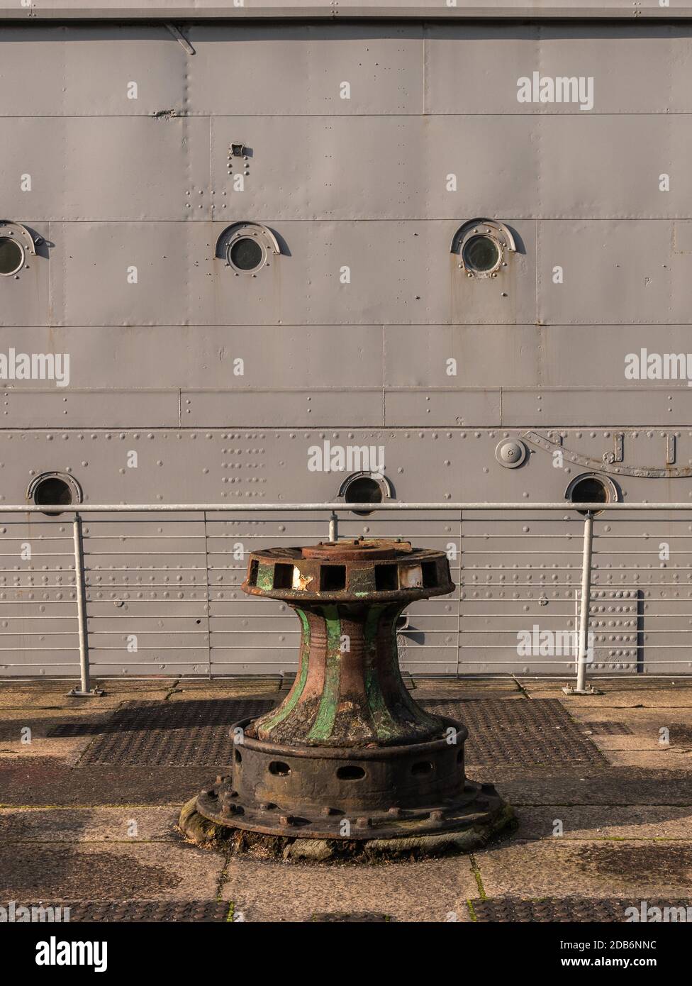 Ships mooring bollard, Alexandra Dock, Belfast, Northern Ireland. HMS Caroline is in background Stock Photo