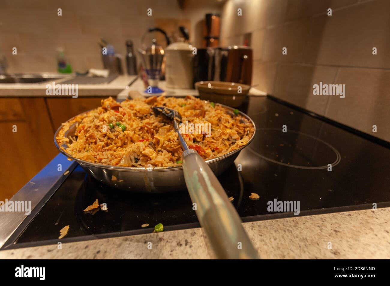 Chicken and chorizo jambalaya. Pan is on cooker with ladle Stock Photo
