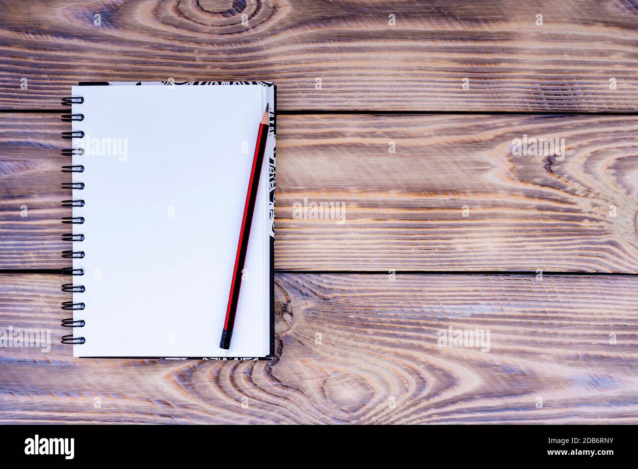 Blank notepad and pencil on wooden background Stock Photo