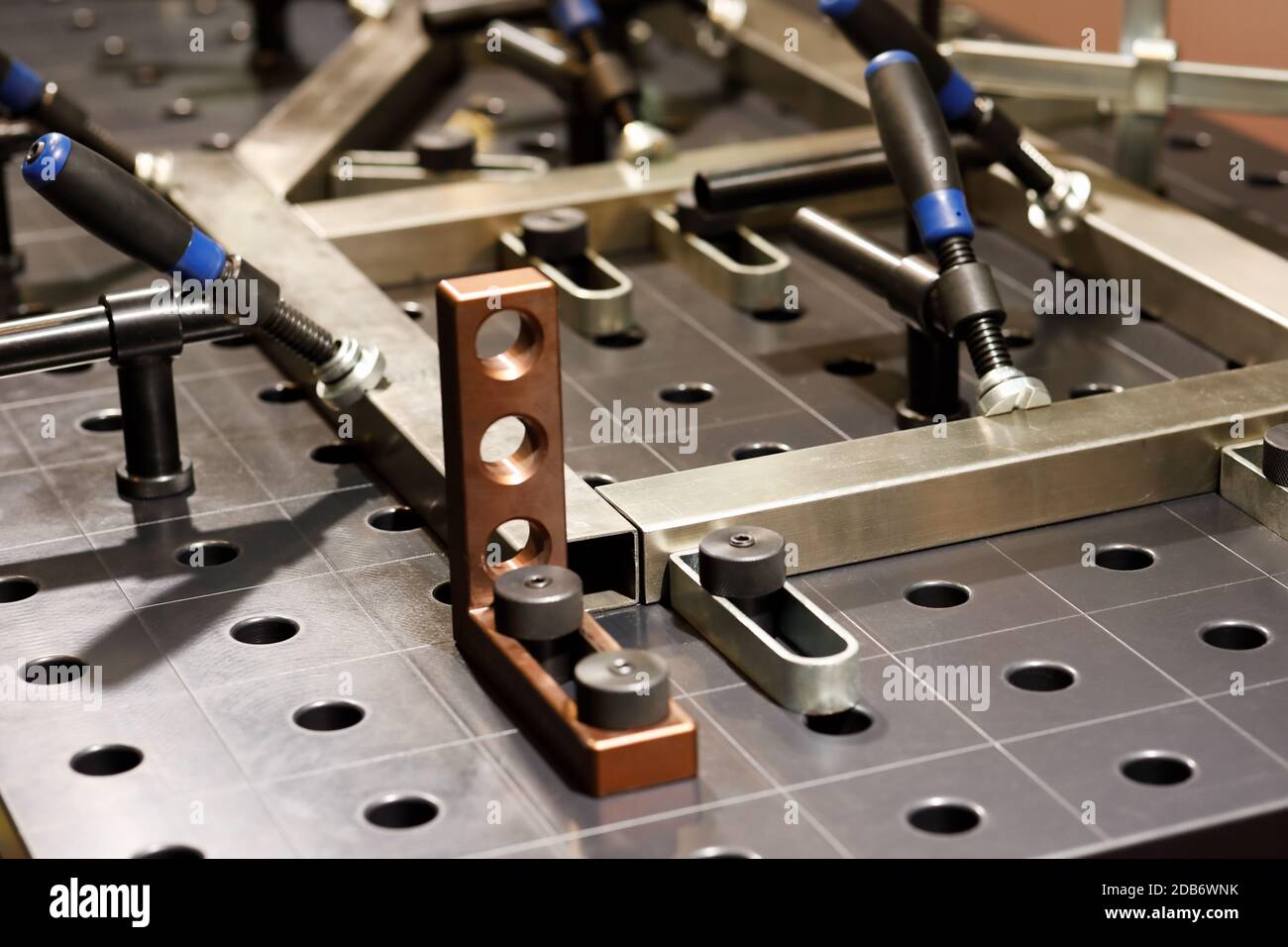 Welding platen table with fixtures and jig design. Selective focus. Stock Photo