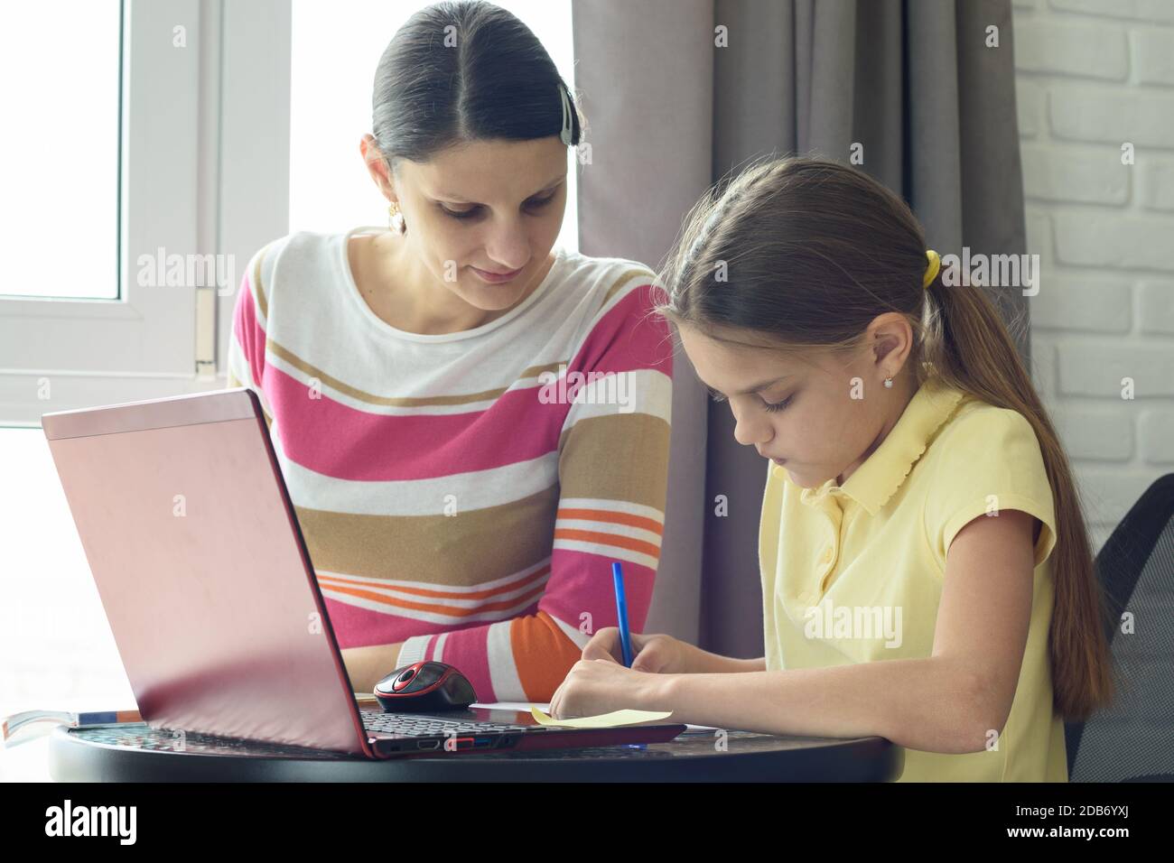 Tutor and teaching do homework by the window in the room Stock Photo ...