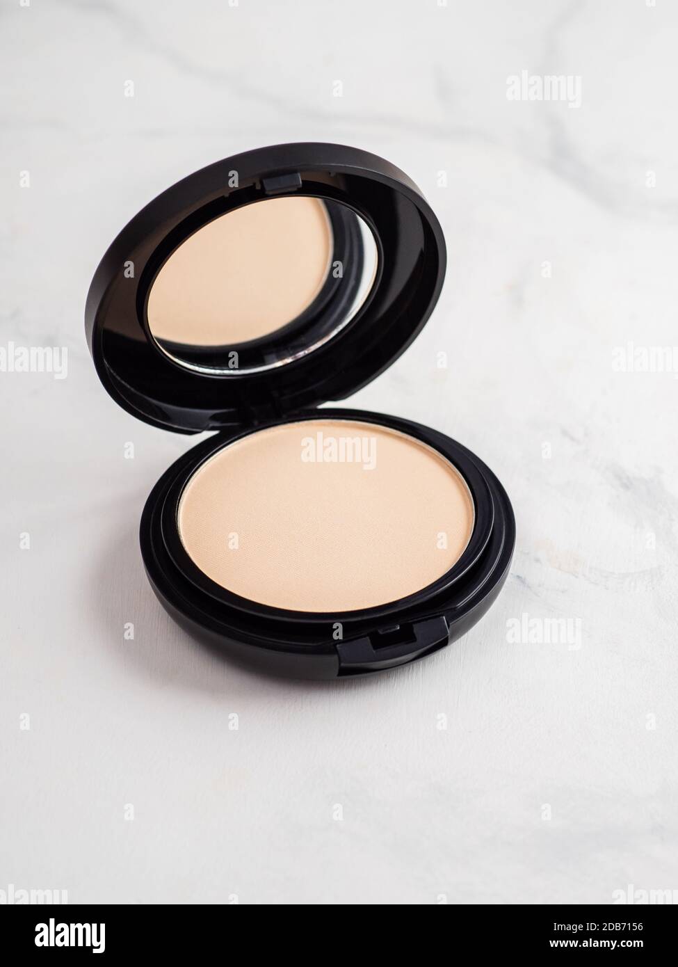 Pretty Pressed Powder Compact Compact powder on white marble background. Female pressed powder in ...