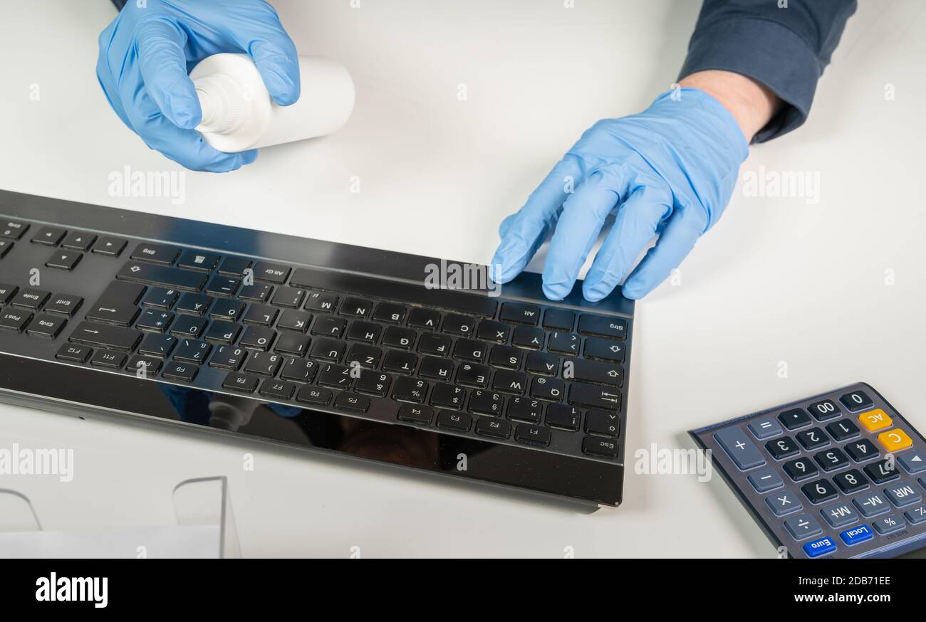 Computer Keyboard Hygiene a person cleans the computer keyboard with a disinfectant Stock Photo ...