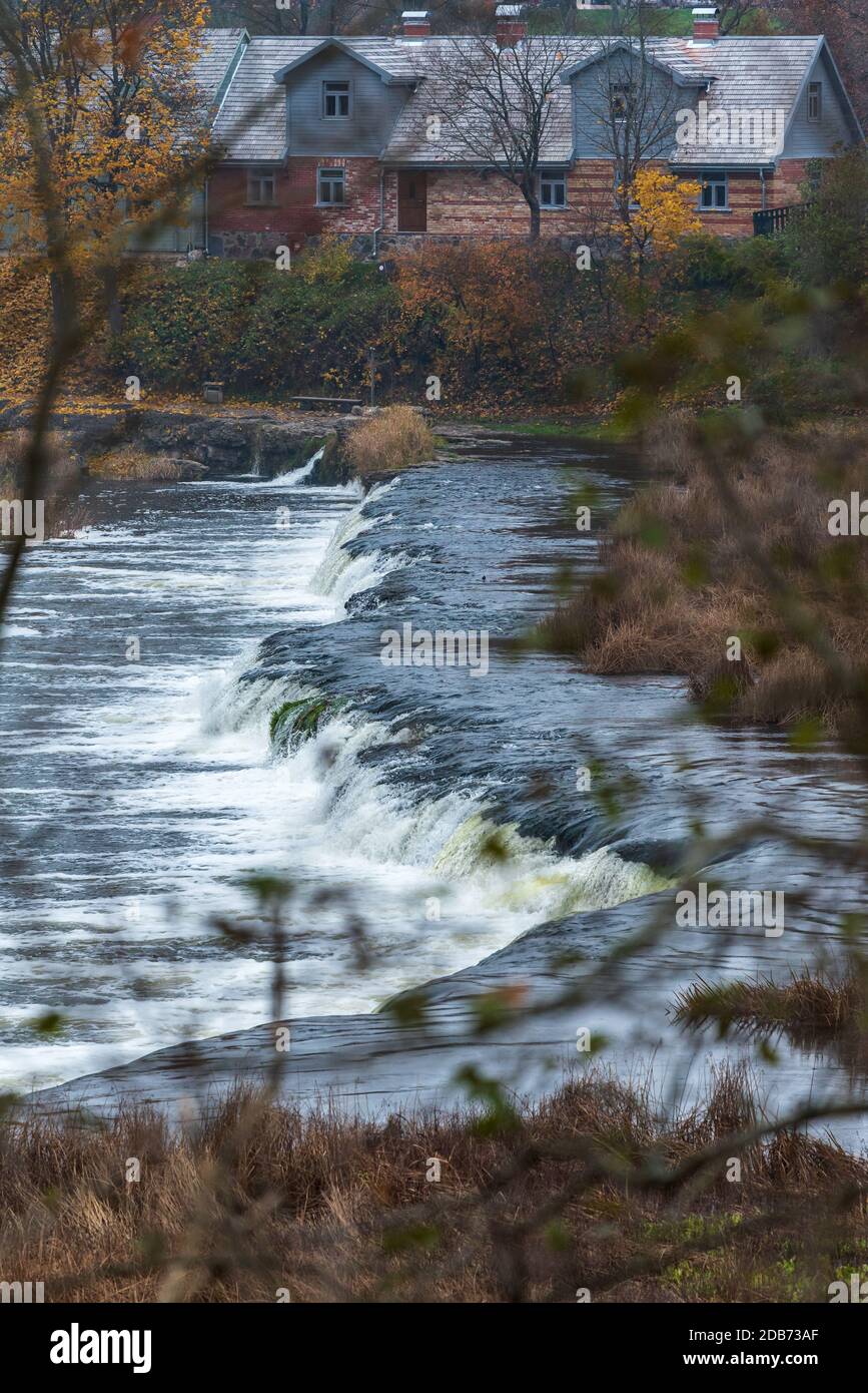 a wide river waterfall with small falls surrounded by autumn colors Stock Photo