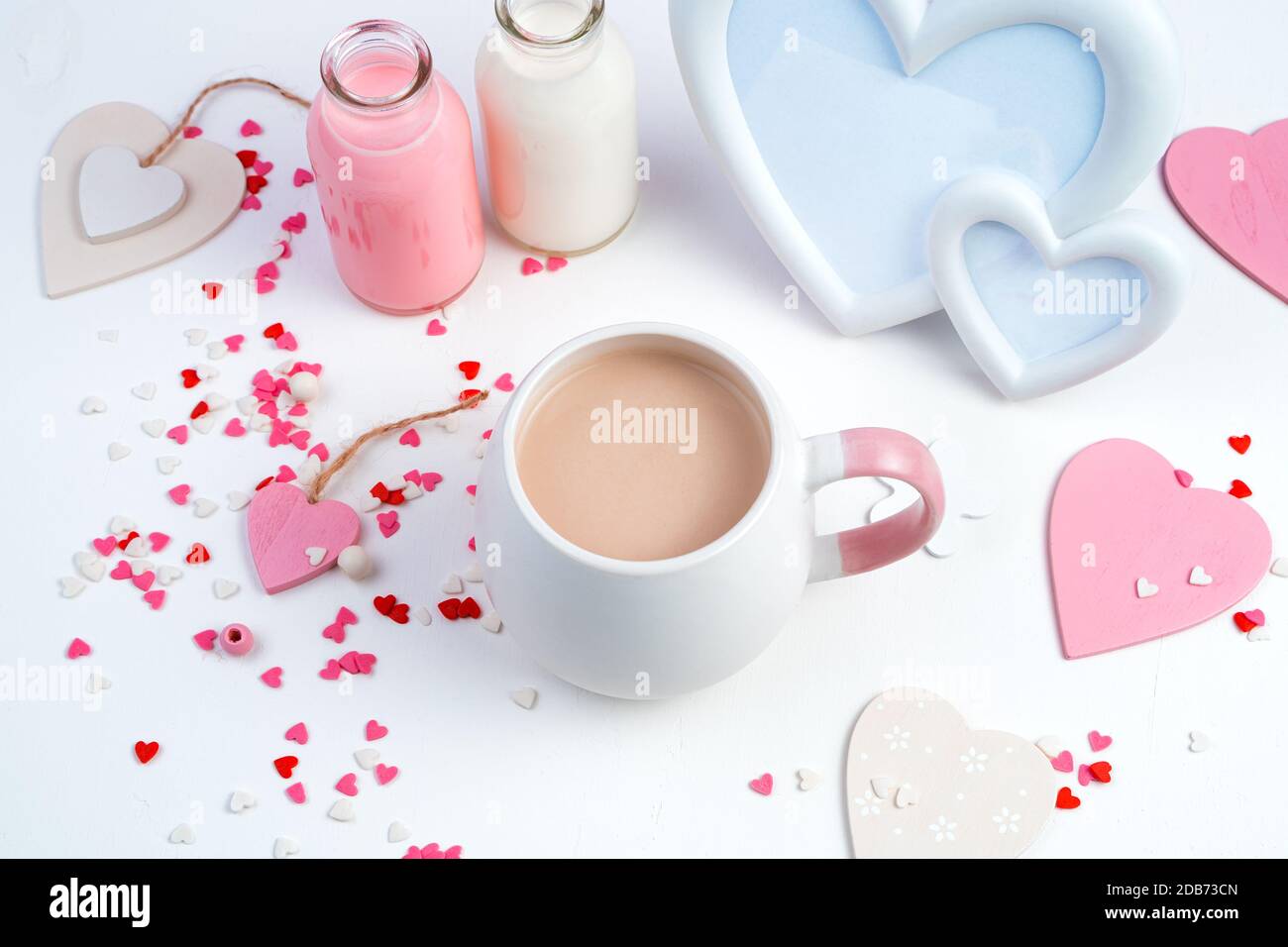 A Cup Of Milk Coffee On A Romantic Background With Hearts And Milk Bottles On A White Background Stock Photo Alamy