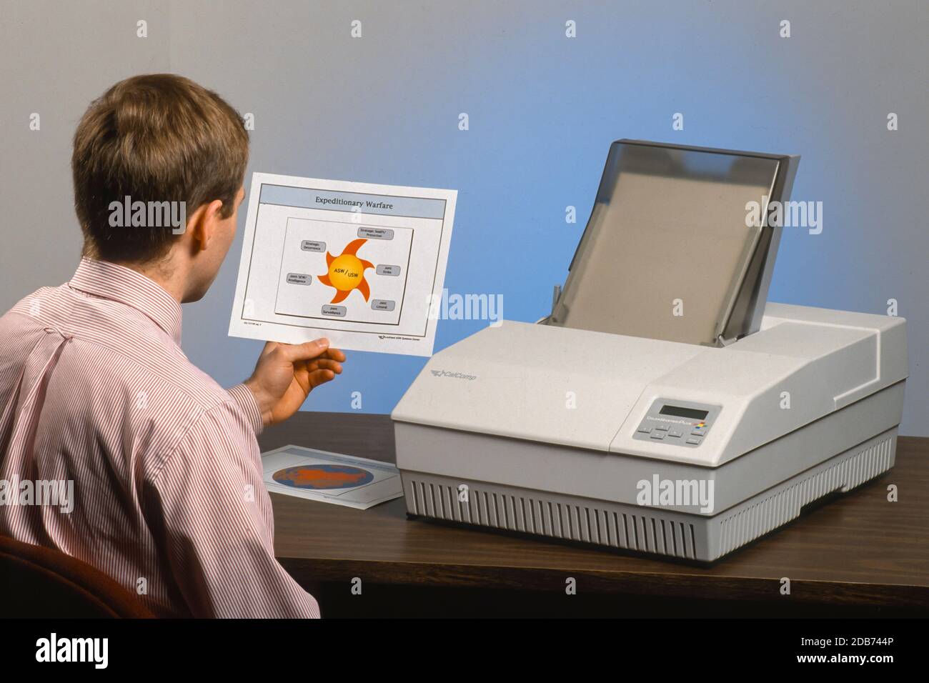 MCLEAN, VIRGINIA, USA, APRIL 7, 1993 - Lockheed employee with Calcomp ColorMaster Plus printer on desk. Stock Photo