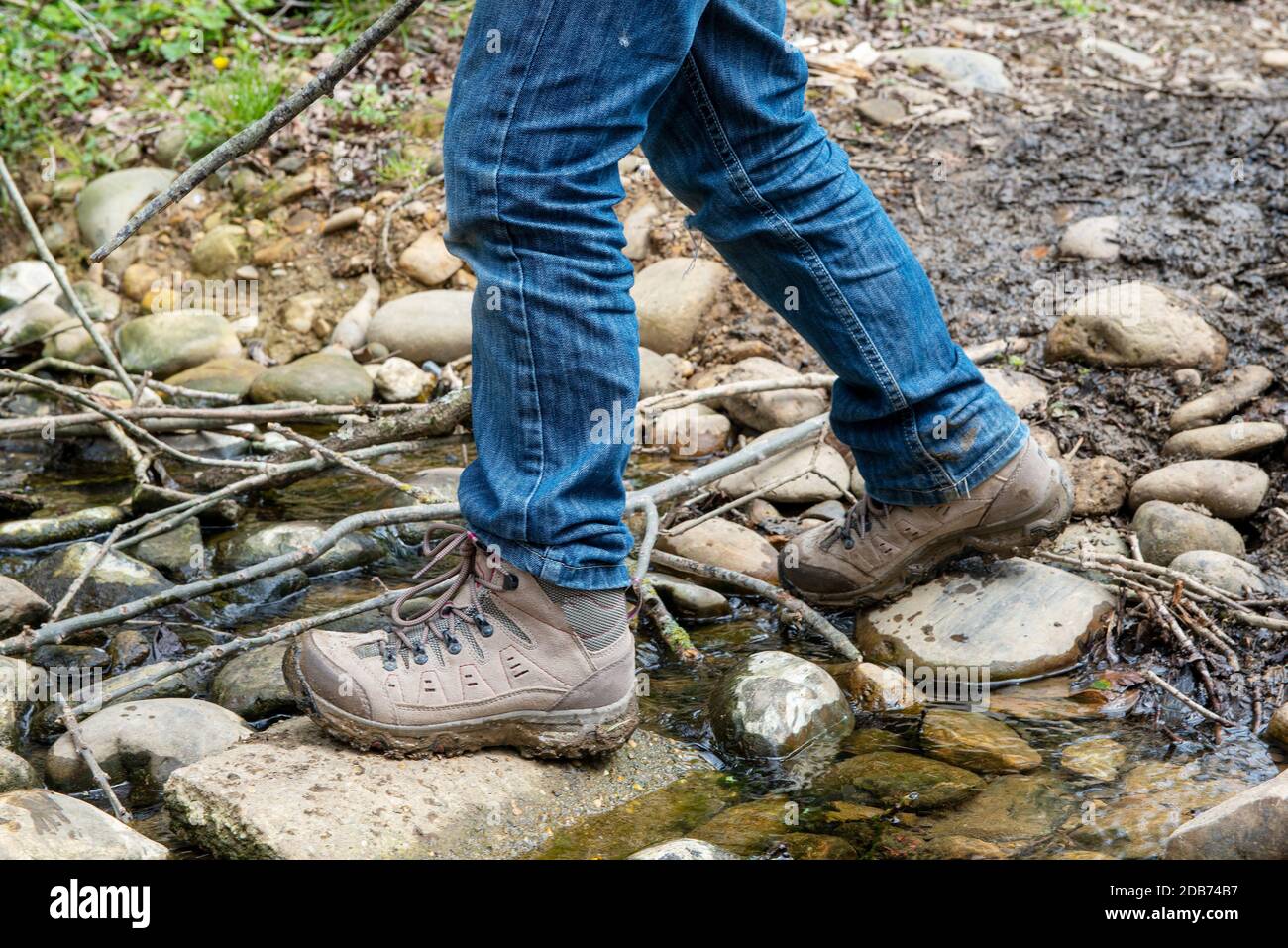 Hiker's shoe while crossing a brook Stock Photo