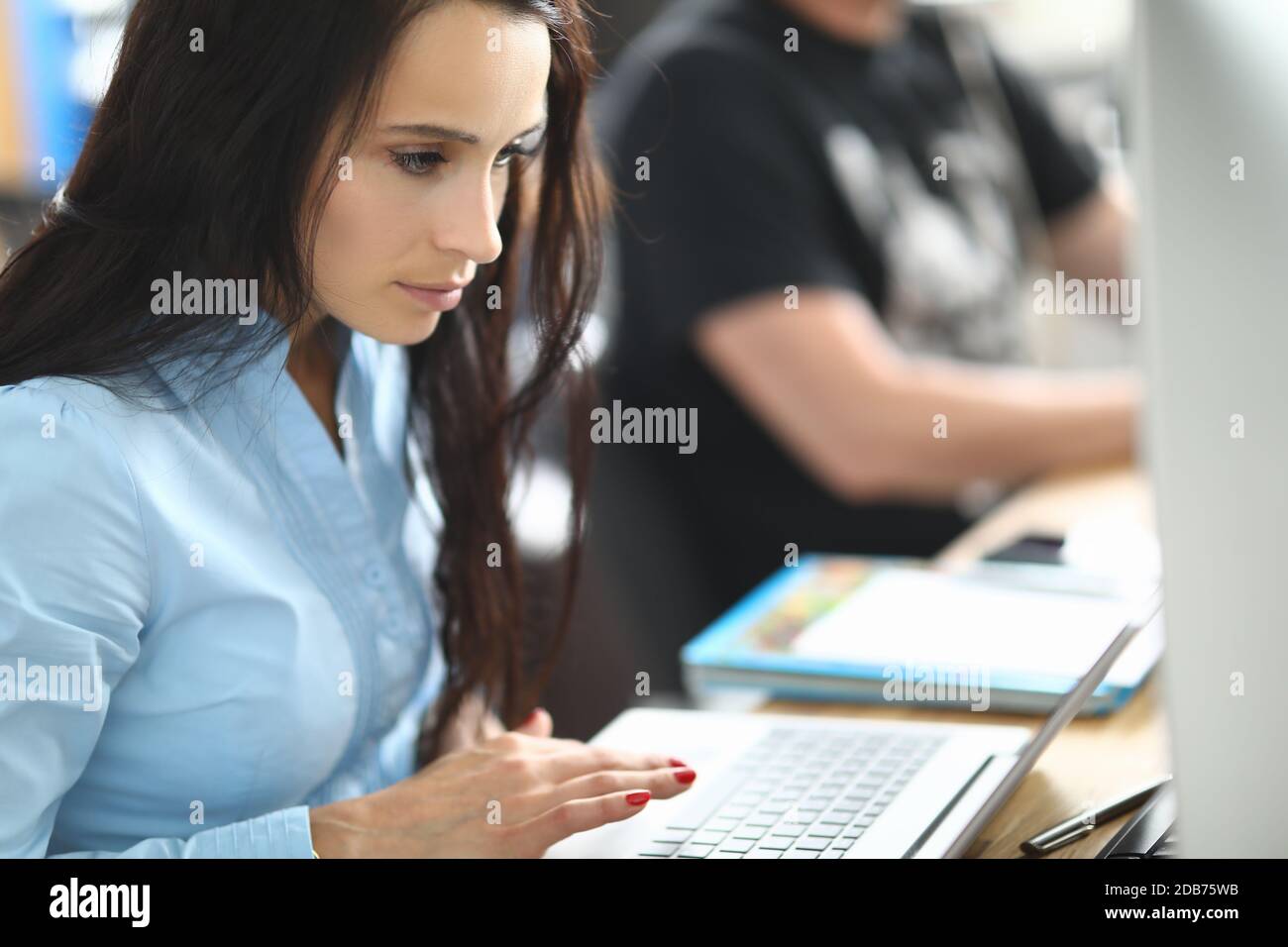 Attractive serious lady in cabinet Stock Photo