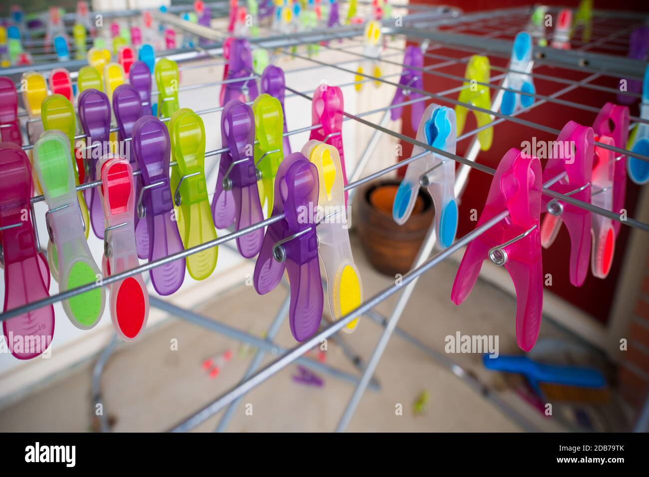 lots of colorful clothespins on a drying rack Stock Photo