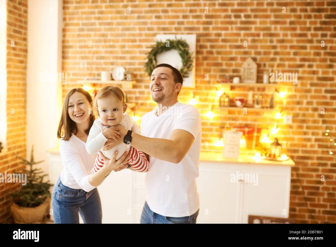 Christmas background. Young family with a small child having fun at Christmas at home. Stock Photo