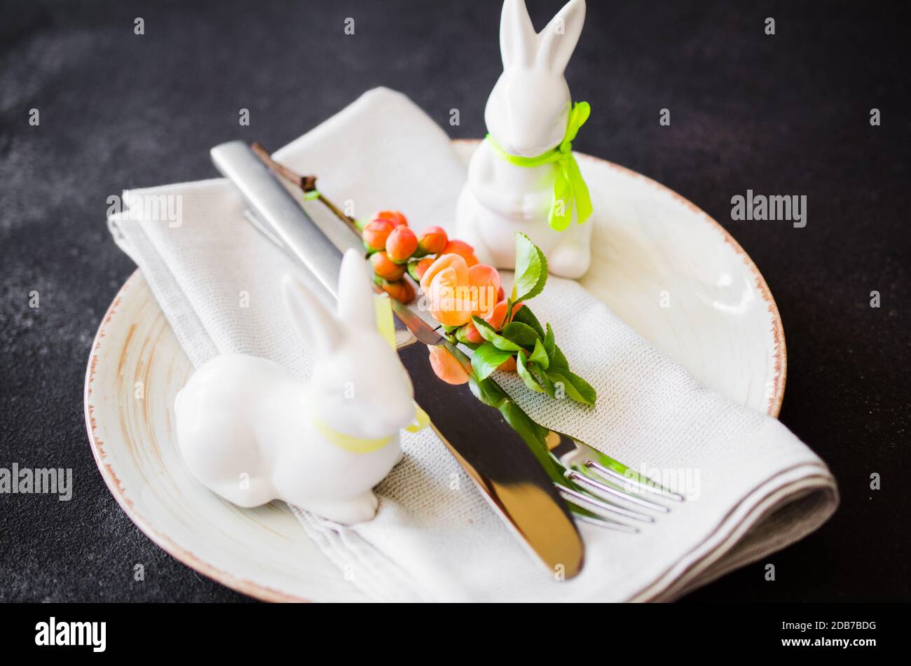 Easter table setting with spring flowering branches, cutlery and ...