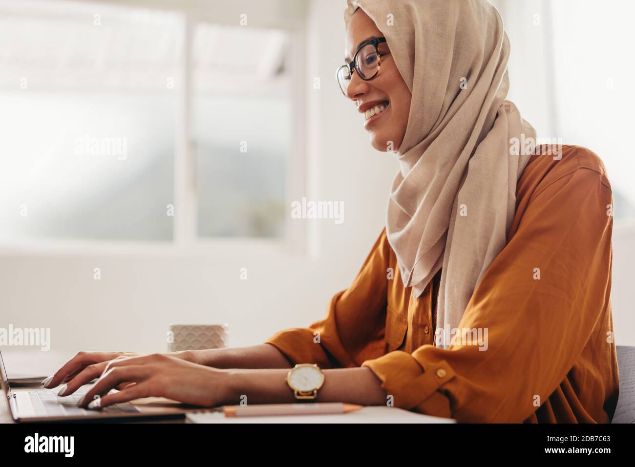 Muslim businesswoman working from home. Woman sitting at home using a ...