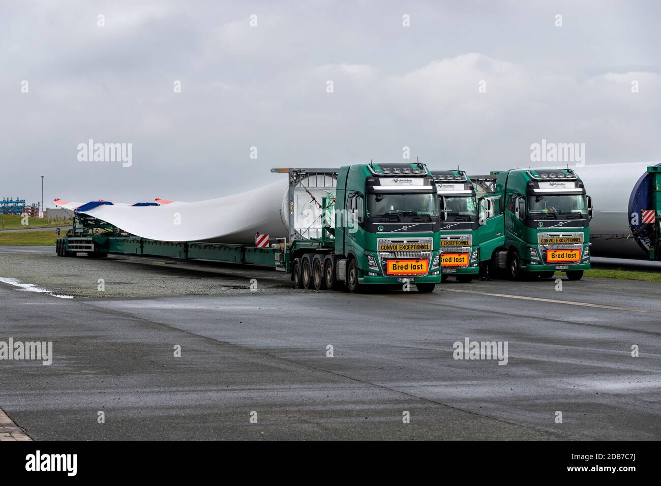 heavy haulage trucks loaded with rotor blade of a wind turbine Stock Photo