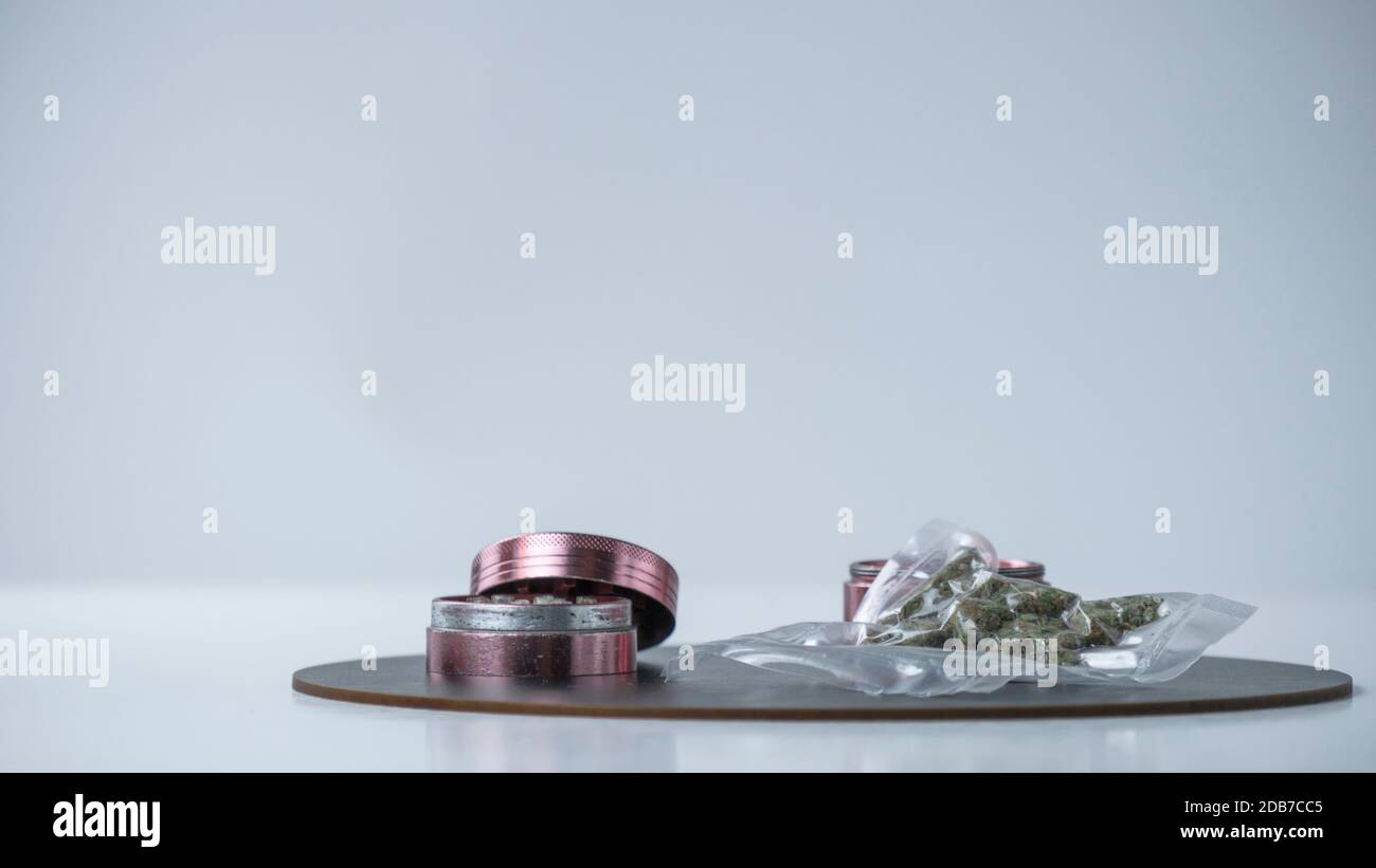 Closeup of medical marijuana buds in vacuum seal bags and grinder