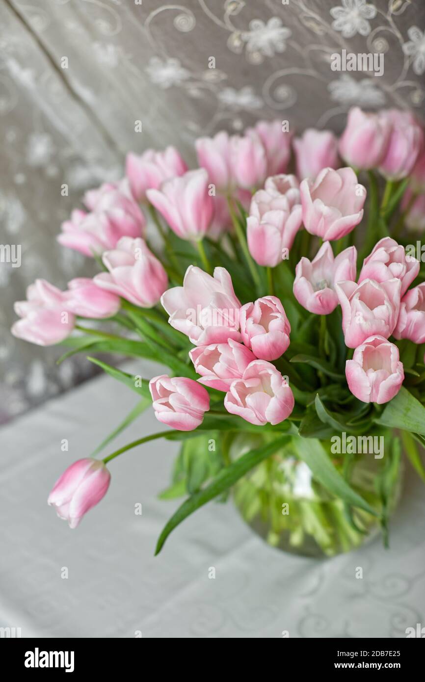 Decor and a vase with pink tulips on a table. Selective focus Stock ...