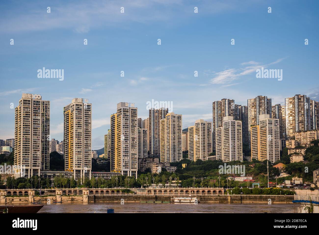 Chongqing, China - August 2019 : Residential blocks of flats on the bank of Yangtze river in Chongqing town in summer Stock Photo