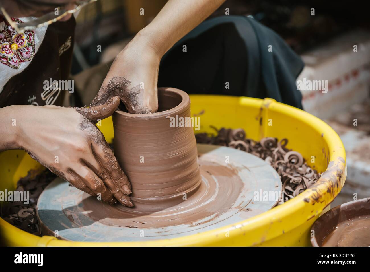 Chongqing, China - August 2019 : Female worker sitting in a workshop making ceramic pottery for sale, Ci Qi Kou Old town Stock Photo