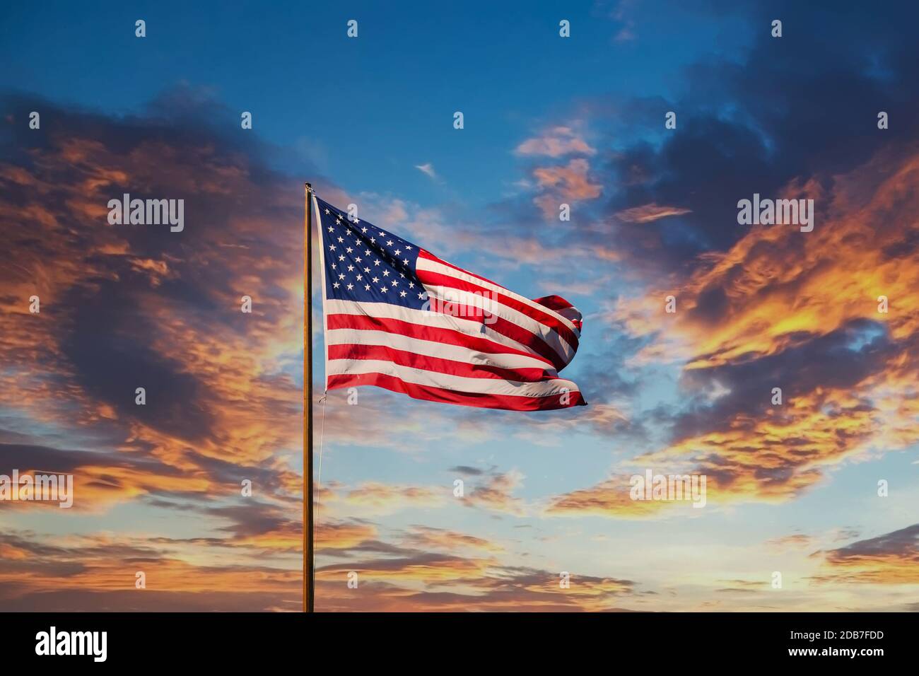 An American flag against a blue sky on an old rusty flagpole Stock ...