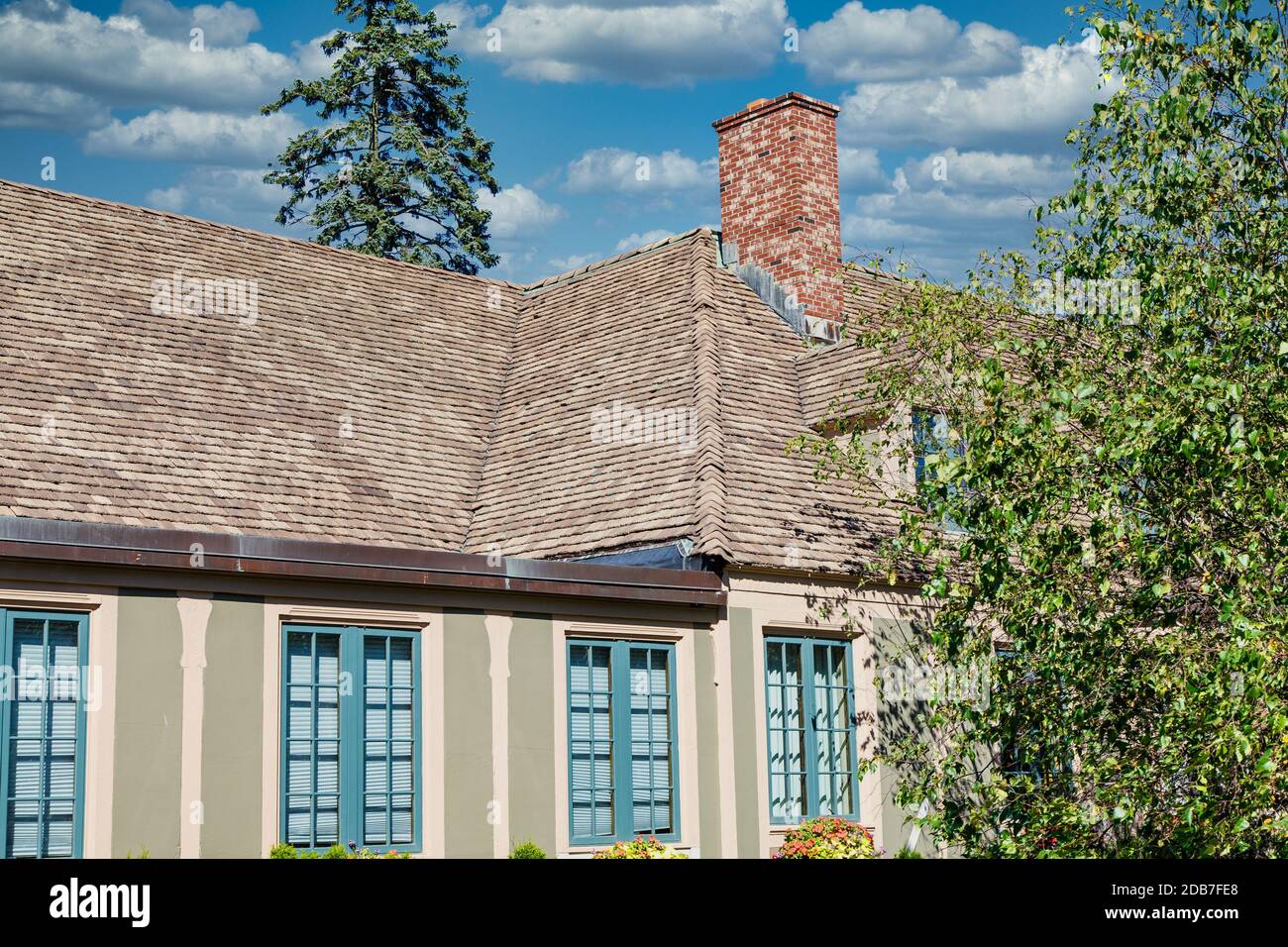 A nice plaster home with shingled roof Stock Photo Alamy