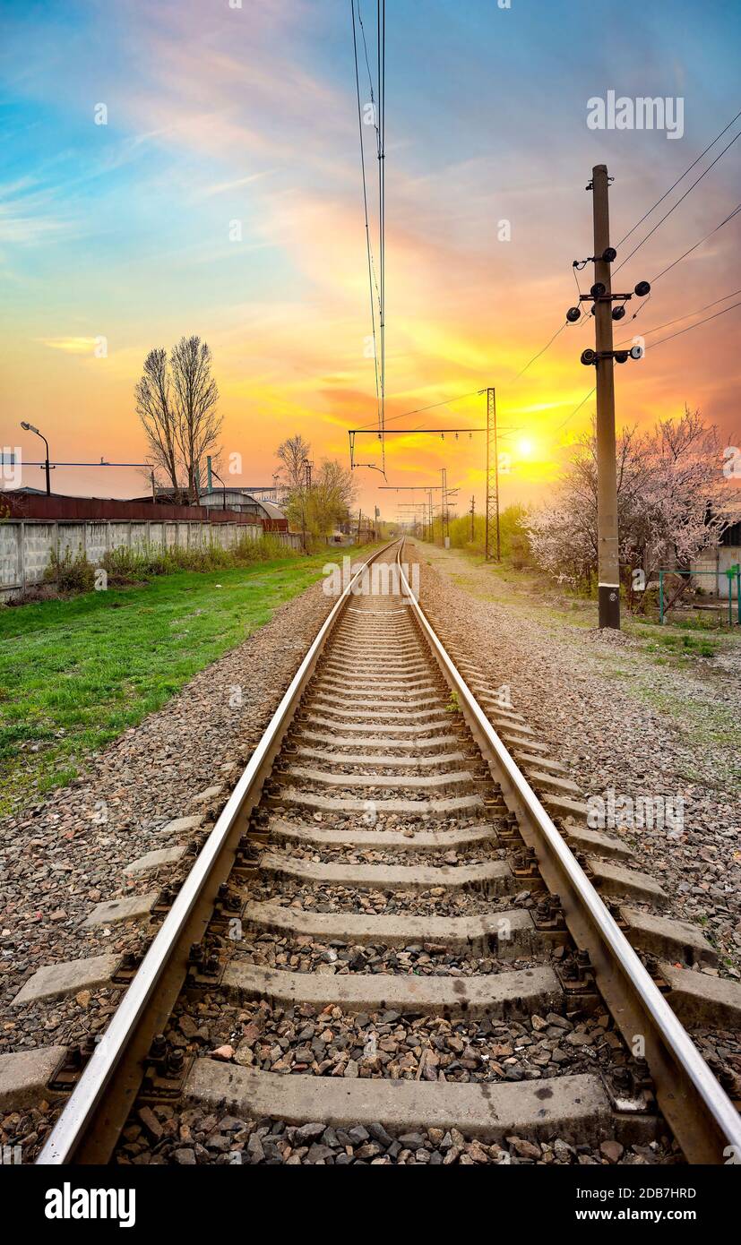Electric poles on a railway station at sunrise Stock Photo - Alamy