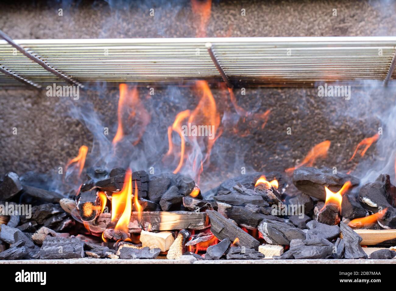 Fire flames smoke charcoal in a grill with grid Stock Photo - Alamy