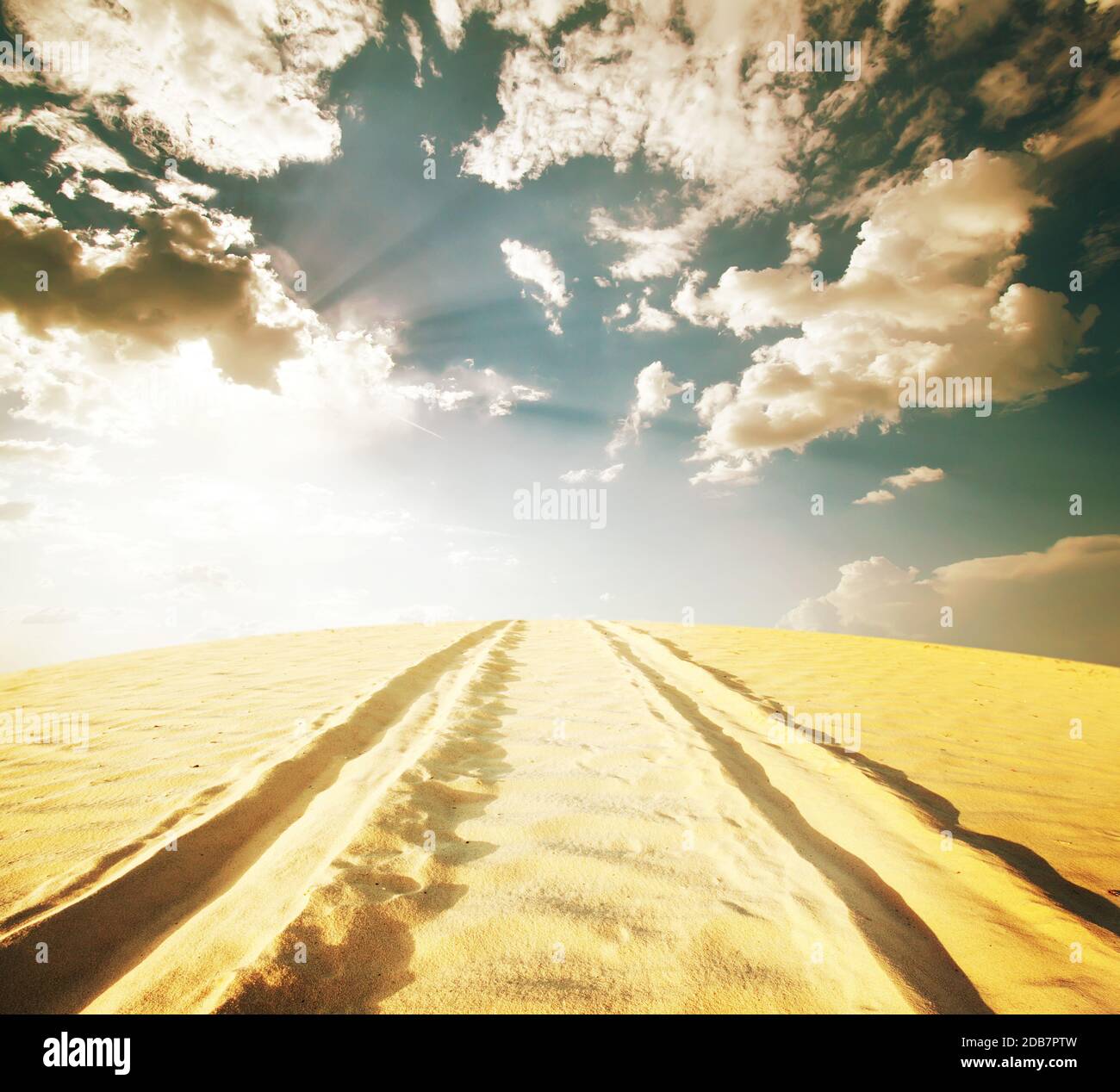 Road in the desert under cloudy sky Stock Photo - Alamy