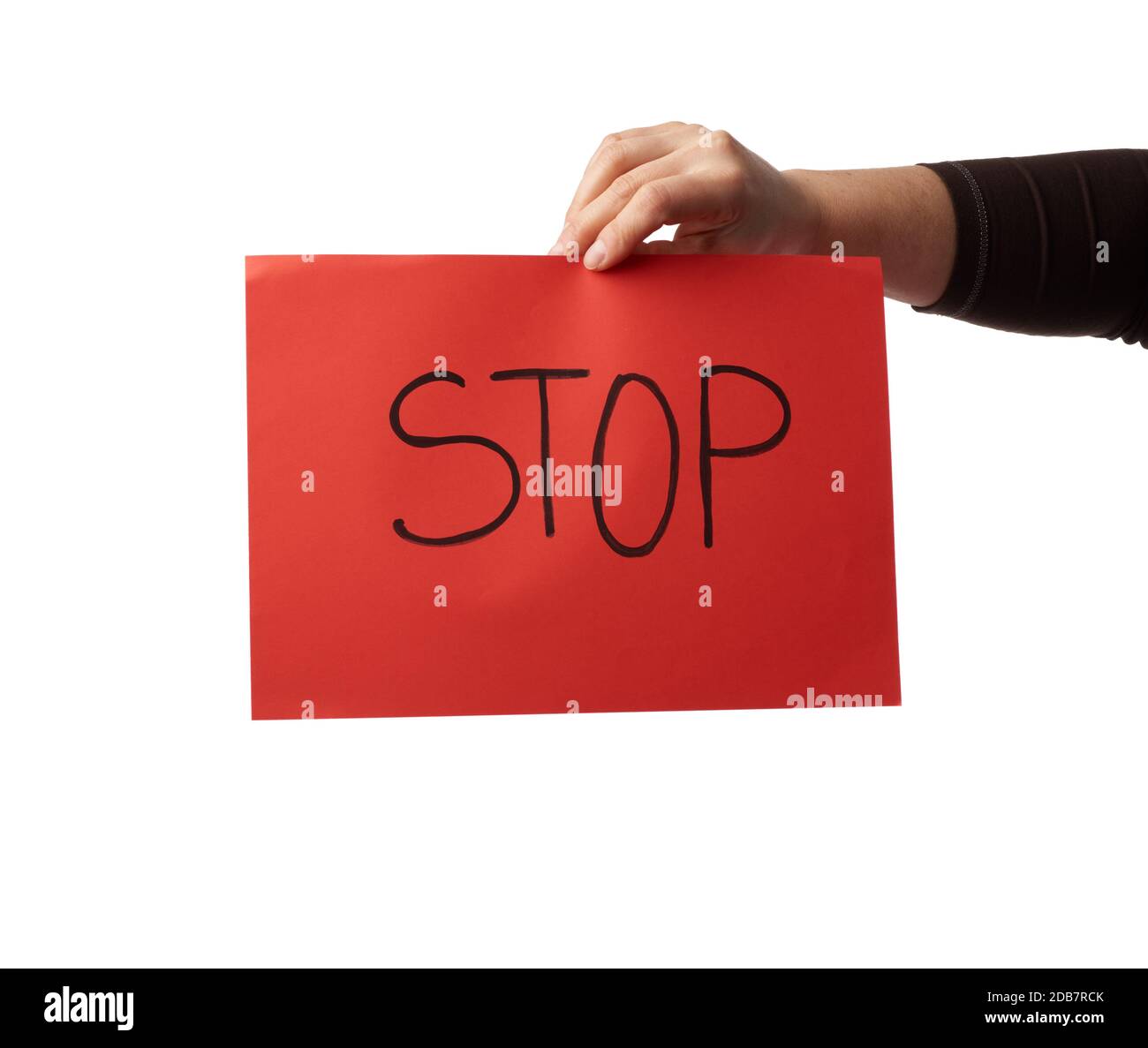 female hand holds a red sheet of paper with the inscription stop, do