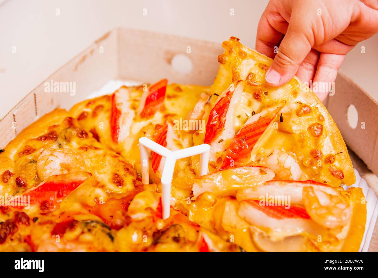 Hot Homemade, Vegetarian fast Italian food, Hand of Little Child holding Delivery Pizza pepperoni, cheese many slices in an open cardboard box Stock Photo