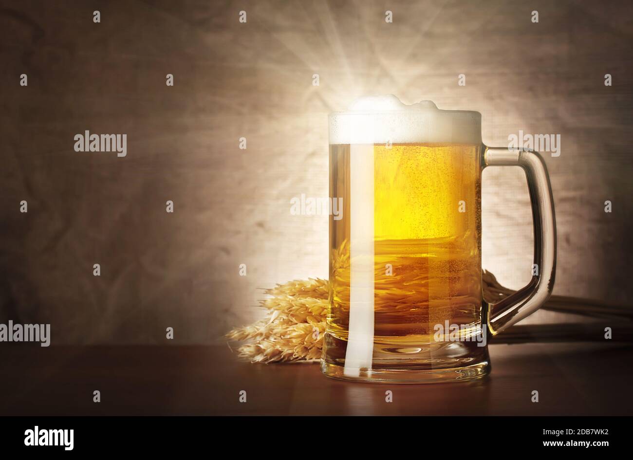 Mug of lager beer with a solar flare on burlap background Stock Photo