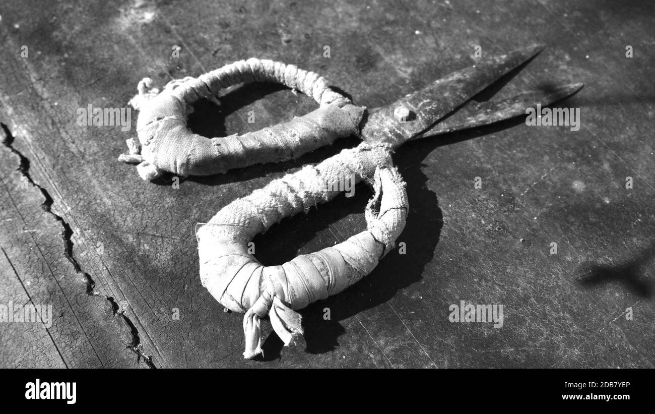 Vintage scissors on wood background. Old cutting tool. Black and white