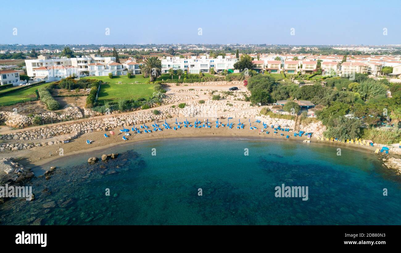 Aerial bird's eye view of Sirena beach in Protaras, Paralimni, Famagusta, Cyprus. The famous Sirina bay tourist attraction with sunbeds, golden sand, Stock Photo