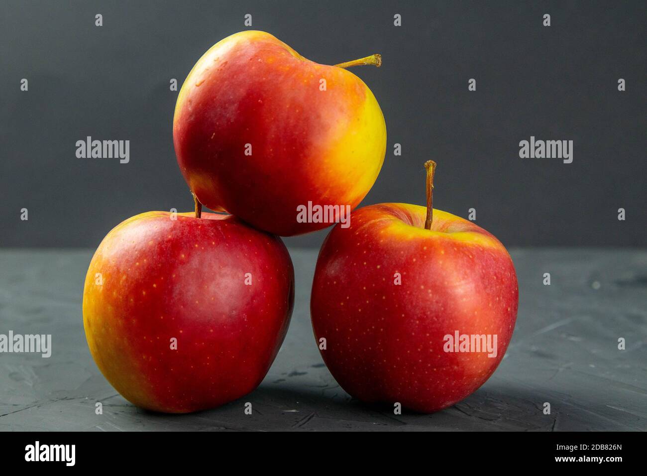 Apples on black stone table background. Front views Stock Photo