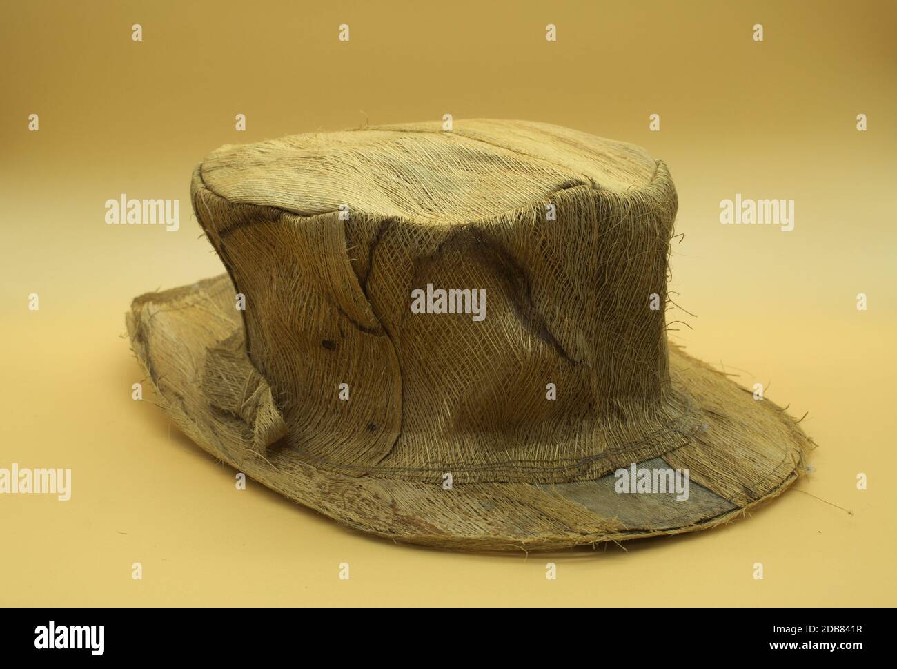 Handmade palm leaf hat isolated on neutral orange background Stock Photo